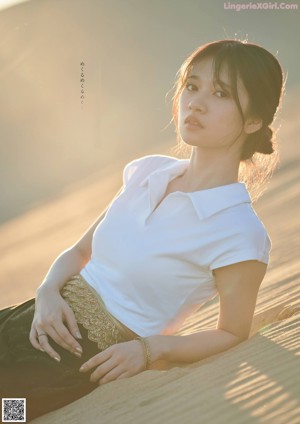A woman in a white shirt is posing for a magazine cover.