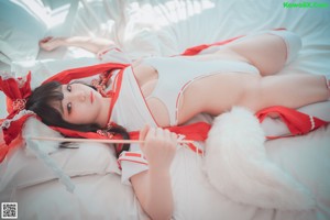 A woman in a red and white outfit is posing for a picture.