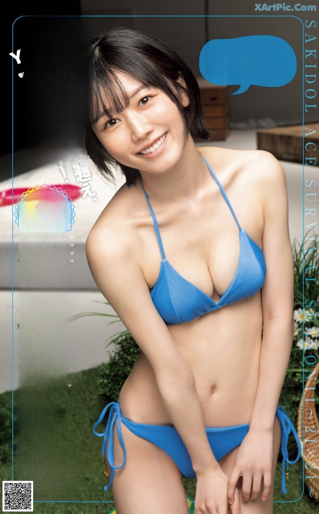 A woman in a blue bikini posing for a magazine cover.