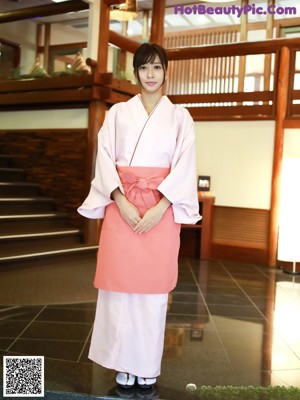 A woman in a white bra and panties posing for the camera.