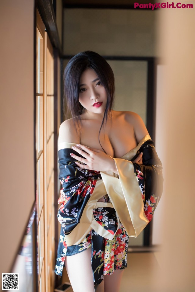 A woman in a kimono posing for a picture.