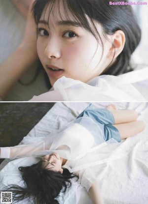 A woman laying on top of a bed covered in white sheets.