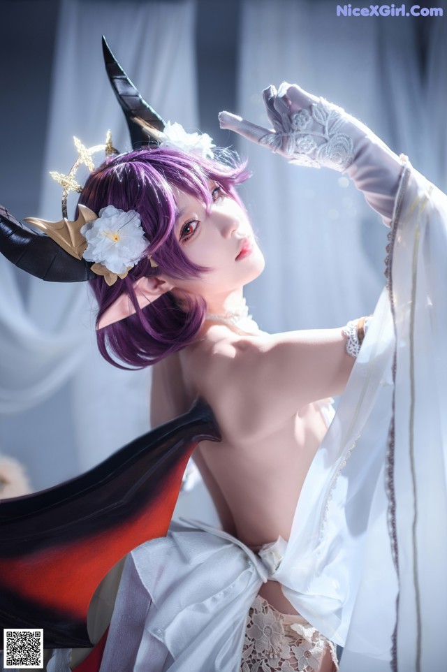 A woman in a white dress with purple hair and horns.