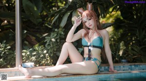 A woman in a bikini standing in a pool.