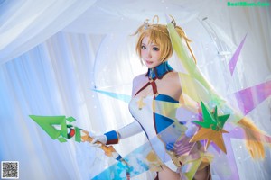 A woman in a white and blue outfit is posing for a picture.