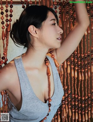 A woman in a blue bra and white pants posing for a magazine.