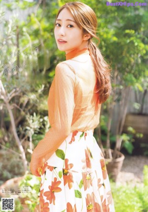 A woman in a kimono is posing for a magazine.